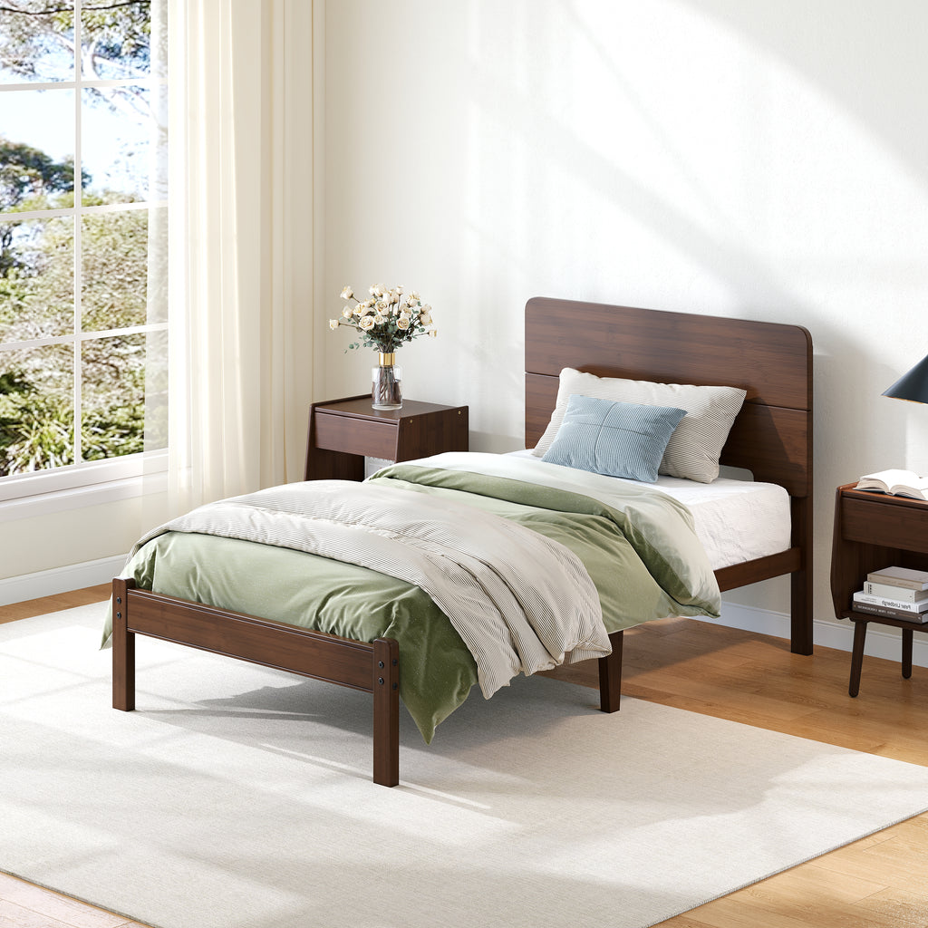 Queen size walnut bed frame styled in a mid century modern bedroom